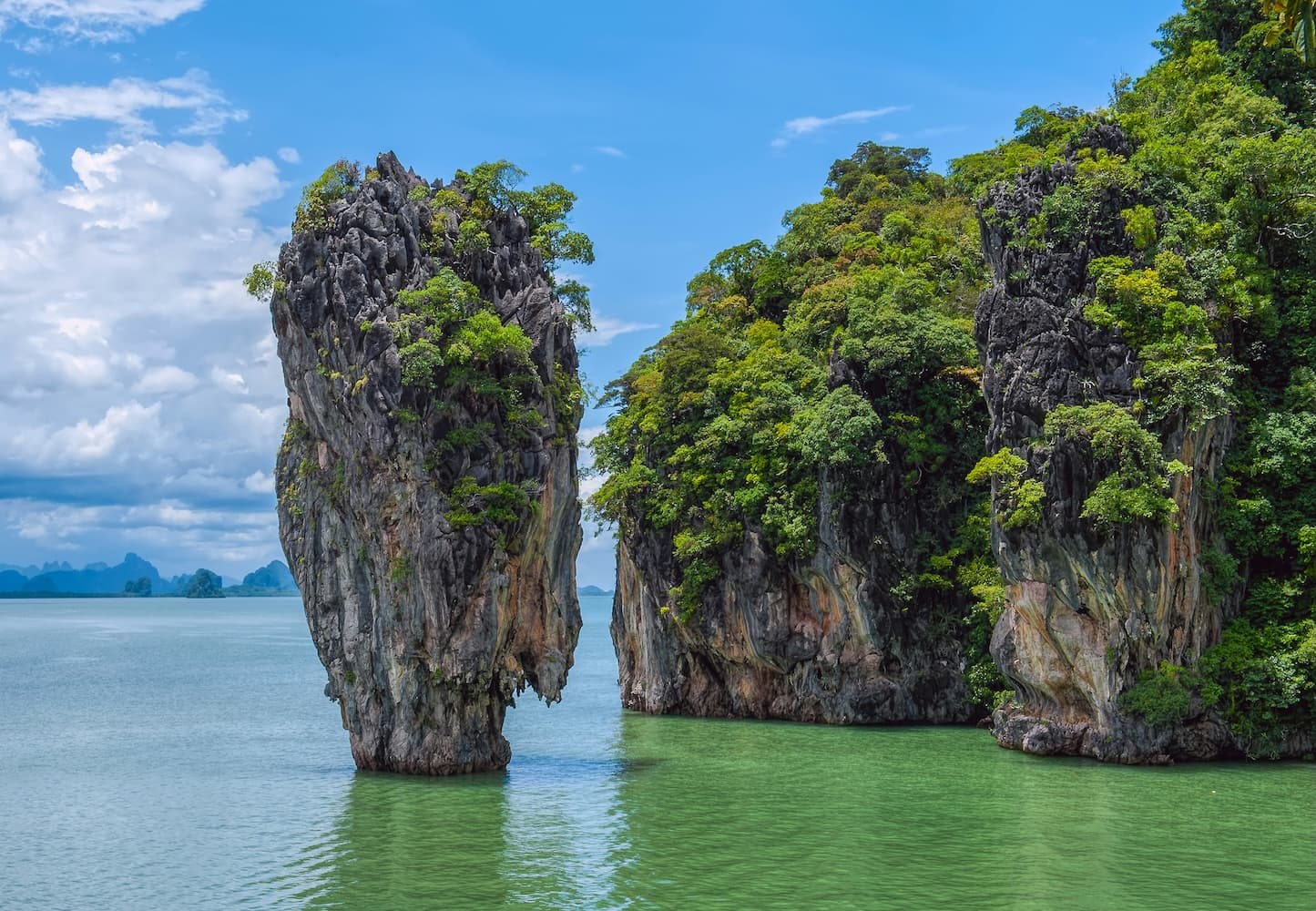 Luxury yacht sailing beside limestone cliffs in Phuket, Thailand